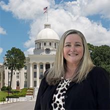 Photo of Beth Edwards with Alabama state capitol in background