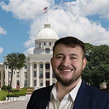 Photo of Logan Burgess with Alabama state capitol in background