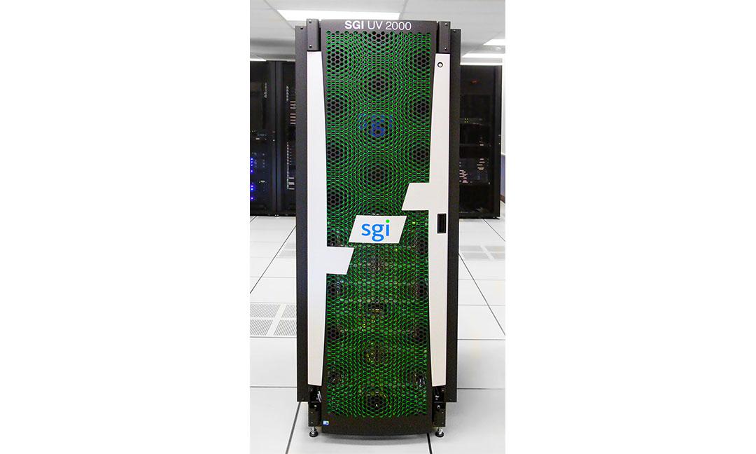 A tall, vertical server rack for an SGI UV 2000 supercomputer. The front door features a distinctive green mesh pattern behind a white geometric overlay, with the blue "sgi" logo centered. The unit is standing on a tiled raised floor inside a data center, with other server racks visible in the background.