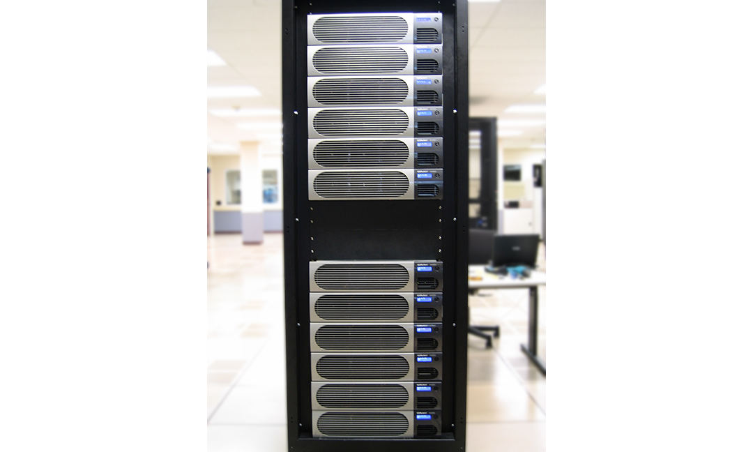 Front view of Cray XD1 tall black tower with silver and blue accents with blurred server room background